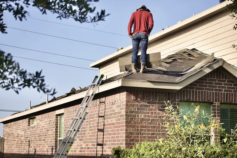 Professional roofer working on a residential roof in Halfmoon